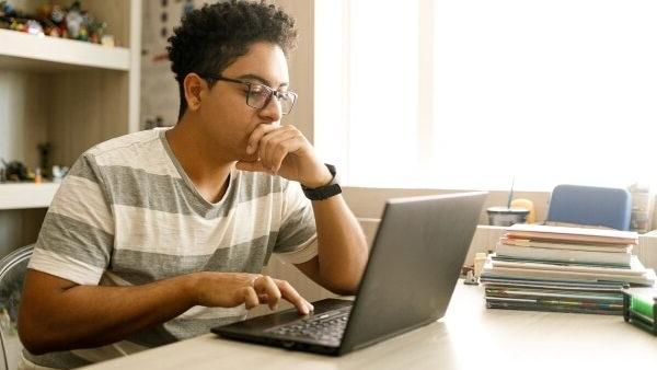 student studying on laptop at home